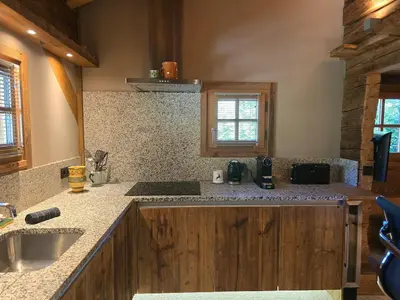 a kitchen with a sink and a counter top at Le Mazot in Megève