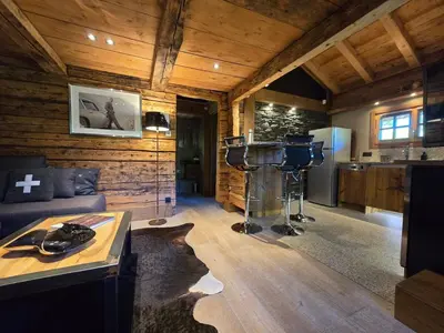 a room with a kitchen and a living room with a room at Le Mazot in Megève