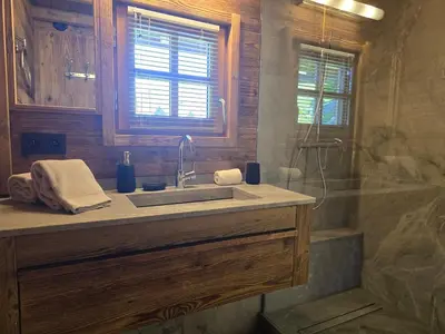 a bathroom with a sink and a shower at Le Mazot in Megève