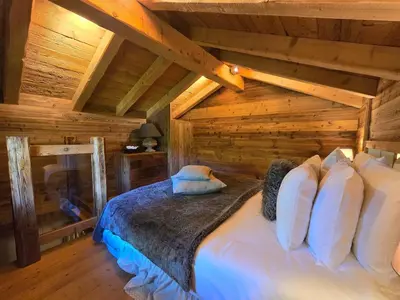 a bedroom with a bed in a log cabin at Le Mazot in Megève