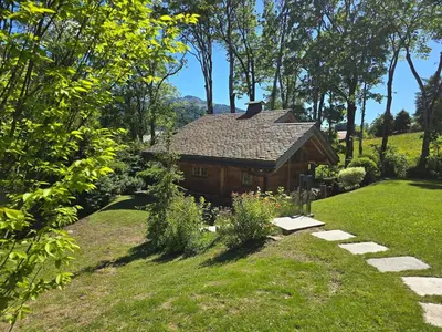 a log cabin in the middle of a yard at Le Mazot in Megève