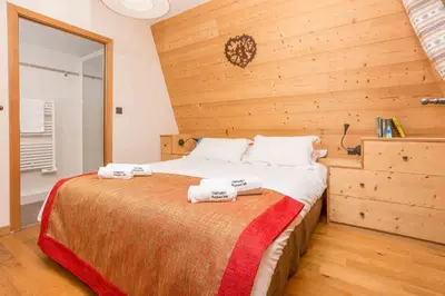 a bedroom with a bed with two towels on it at Le Paradis 18 - Chamonix All Year in Chamonix-Mont-Blanc