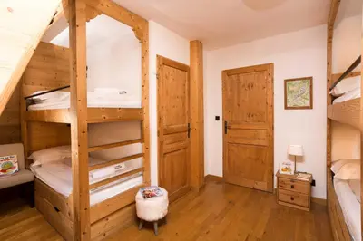 a room with two bunk beds and a door at Le Paradis 18 - Chamonix All Year in Chamonix-Mont-Blanc