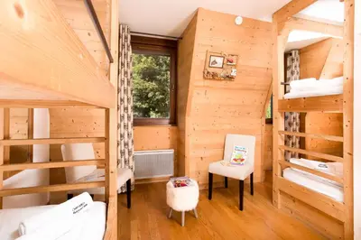 a room with two bunk beds and a window at Le Paradis 18 - Chamonix All Year in Chamonix-Mont-Blanc