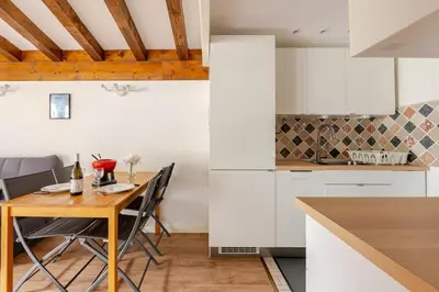 a kitchen and dining room with a table and chairs at Studio avec vue sur les montagnes in Les Contamines-Montjoie