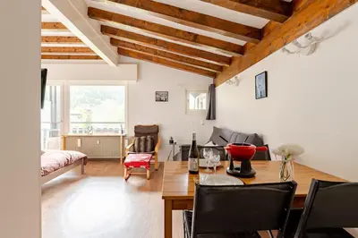a living room with a table and a couch at Studio avec vue sur les montagnes in Les Contamines-Montjoie