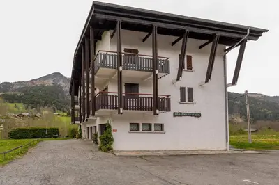 a white building with balconies on the side of it at Studio avec vue sur les montagnes in Les Contamines-Montjoie