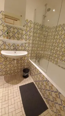 a bathroom with a sink and a shower and a mirror at Studio avec vue sur les montagnes in Les Contamines-Montjoie