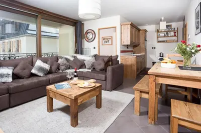 a living room with a couch and a table at Le Paradis ski apartment - Chamonix All Year in Chamonix-Mont-Blanc