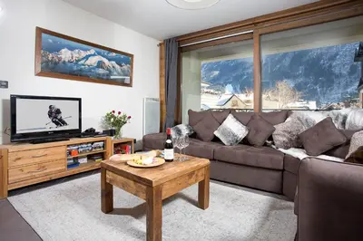 a living room with a couch and a table at Le Paradis ski apartment - Chamonix All Year in Chamonix-Mont-Blanc