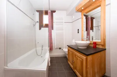 a bathroom with a tub and a sink and a shower at Le Paradis ski apartment - Chamonix All Year in Chamonix-Mont-Blanc