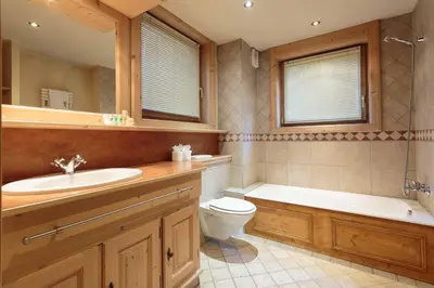 a bathroom with a tub and a toilet and a sink at Chamois Apartment- Chamonix All Year in Chamonix-Mont-Blanc