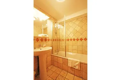 a bathroom with a sink and a shower and a tub and a sink at La Ferme des Praz apartment - Chamonix All Year in Chamonix-Mont-Blanc
