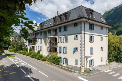 a large white building on the side of a road at Le Paradis 18b - Chamonix All Year in Chamonix-Mont-Blanc