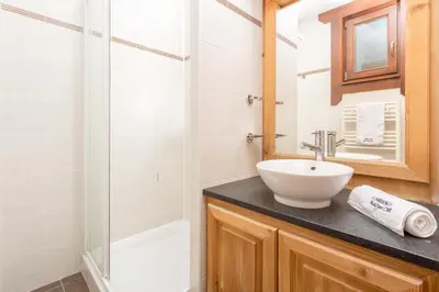 a bathroom with a sink and a shower at Le Paradis 18b - Chamonix All Year in Chamonix-Mont-Blanc
