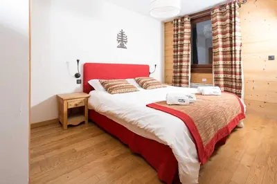 a bedroom with a bed with two towels on it at Le Paradis 18b - Chamonix All Year in Chamonix-Mont-Blanc