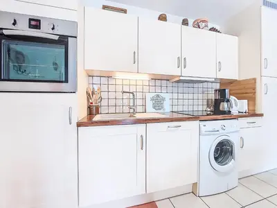 a kitchen with white cabinets and a washer and dryer at Apartment Domaine de Crespin-6 by Interhome in Saint-Gervais-les-Bains