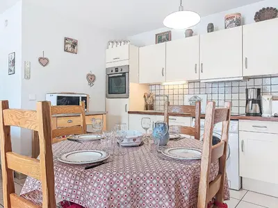 a kitchen with a table with plates and glasses on it at Apartment Domaine de Crespin-6 by Interhome in Saint-Gervais-les-Bains