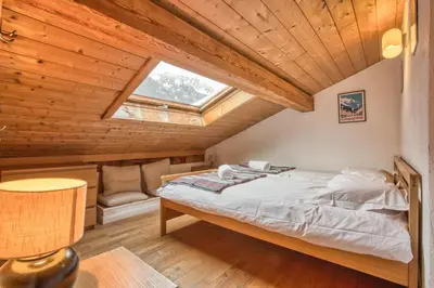 a bedroom with a bed in a wooden ceiling at Apartment Vila 2 - Charming 2 Bedroom Haven in Chamonix in Chamonix-Mont-Blanc