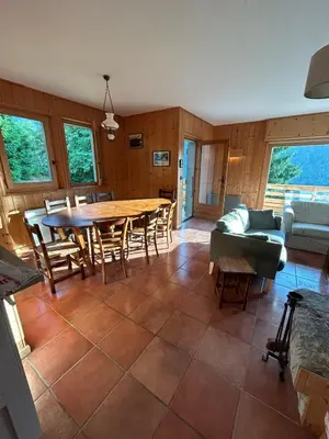 a living room with a table and chairs and a couch at Carpe Diem in Sixt