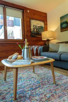 a bedroom with a bed and a desk and a chair at Edelweiss 2 Apartment and Studio - Chamonix All Year in Chamonix-Mont-Blanc