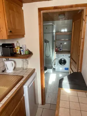 a kitchen with a sink and a washing machine at Studio vallée de Chamonix in Les Houches