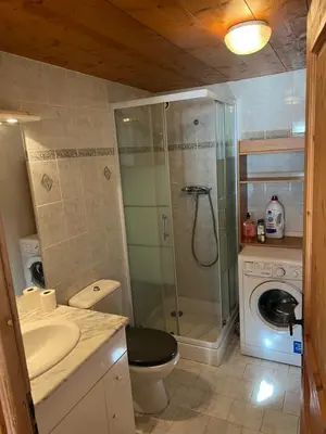 a bathroom with a toilet sink and a shower at Studio vallée de Chamonix in Les Houches