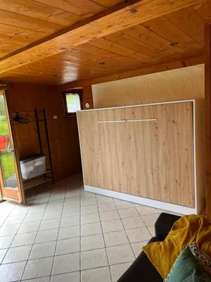 a room with a large wooden door in a house at Studio vallée de Chamonix in Les Houches