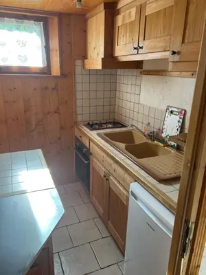 a small kitchen with a sink and a stove at Studio vallée de Chamonix in Les Houches