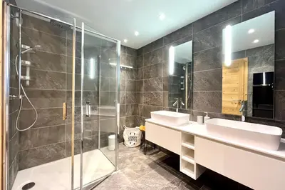 a bathroom with two sinks and a shower at Parenthèse Rochebrune in Megève