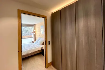 a small bedroom with a bed and a mirror at Parenthèse Rochebrune in Megève