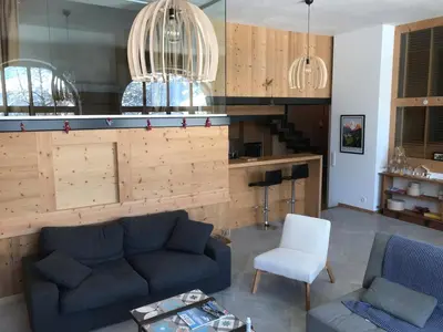 a living room with a couch and a chair at Grand appartement familial in Combloux