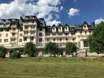 a large white building with a lot of windows at Grand appartement familial in Combloux