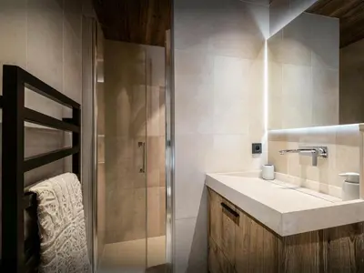 a bathroom with a sink and a shower at Chalet Snow Love - OVO Network in Megève