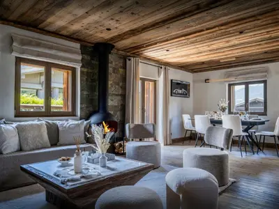 a living room with a couch and a fireplace at Chalet Snow Love - OVO Network in Megève