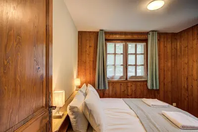 a bedroom with a bed and a window at Apartment Grand Payot, Alpes Travel, Sleeps 2 to 4 in Chamonix-Mont-Blanc