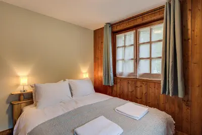 a bedroom with a bed with two towels on it at Apartment Grand Payot, Alpes Travel, Sleeps 2 to 4 in Chamonix-Mont-Blanc