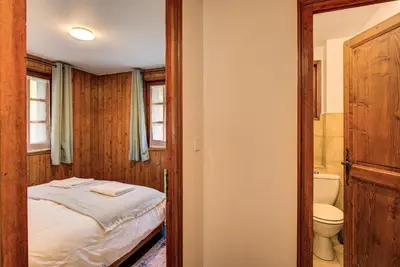 a small bedroom with a bed and a toilet at Apartment Grand Payot, Alpes Travel, Sleeps 2 to 4 in Chamonix-Mont-Blanc