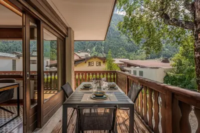 a table on the balcony of a house at Apartment Grand Payot, Alpes Travel, Sleeps 2 to 4 in Chamonix-Mont-Blanc
