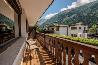 a balcony with a bench and mountains in the background at Apartment Grand Payot, Alpes Travel, Sleeps 2 to 4 in Chamonix-Mont-Blanc