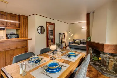 a dining room with a wooden table and chairs at Apartment Grand Payot, Alpes Travel, Sleeps 2 to 4 in Chamonix-Mont-Blanc