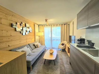 a living room with a couch and a table at Modern apartment Rochebrune ski in ski out in Megève
