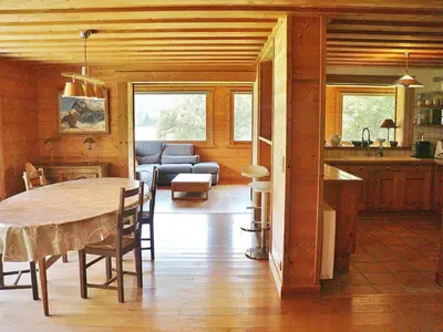 a kitchen and dining room with a table and a couch at Chalet spacieux à Samoëns, proche village, jusqu'à 11 personnes, WiFi, parking - FR-1-815-3 in Samoëns