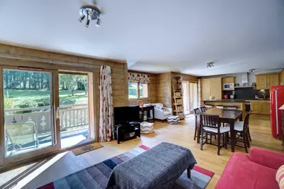 a living room with a couch and a table at Hameaux du glaciers in Les Houches