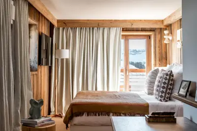 a bedroom with a bed and a large window at Le Refuge Chez La Tante - Mont d'Arbois, ski in - ski out in Saint-Gervais-les-Bains