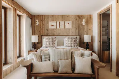 a bedroom with a bed and a couch with pillows at Le Refuge Chez La Tante - Mont d'Arbois, ski in - ski out in Saint-Gervais-les-Bains