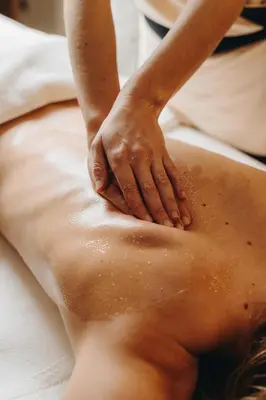 a woman getting a massage on her back at Le Refuge Chez La Tante - Mont d'Arbois, ski in - ski out in Saint-Gervais-les-Bains