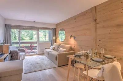 a living room with a table and a couch at Studio Capucines - Welkeys in Megève