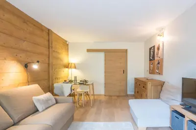 a living room with a couch and a table at Studio Capucines - Welkeys in Megève