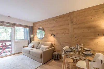 a living room with a couch and a table at Studio Capucines - Welkeys in Megève